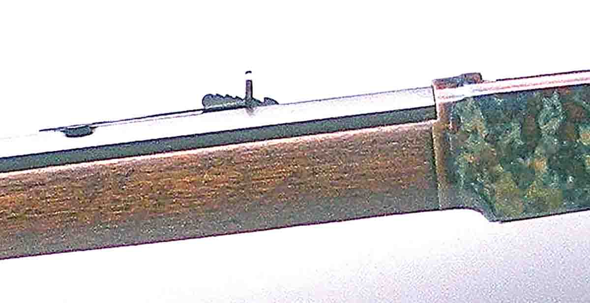 The steep elevator under the rear sight denotes black-powder era. Rifle sights are calibrated for standard .38 WCF black-powder loads in 50-yard increments to 300 yards.